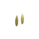 A pair of oval brass earrings against a white background. The Oval Ear Jacket earrings are from Portland designer Natalie Joy.