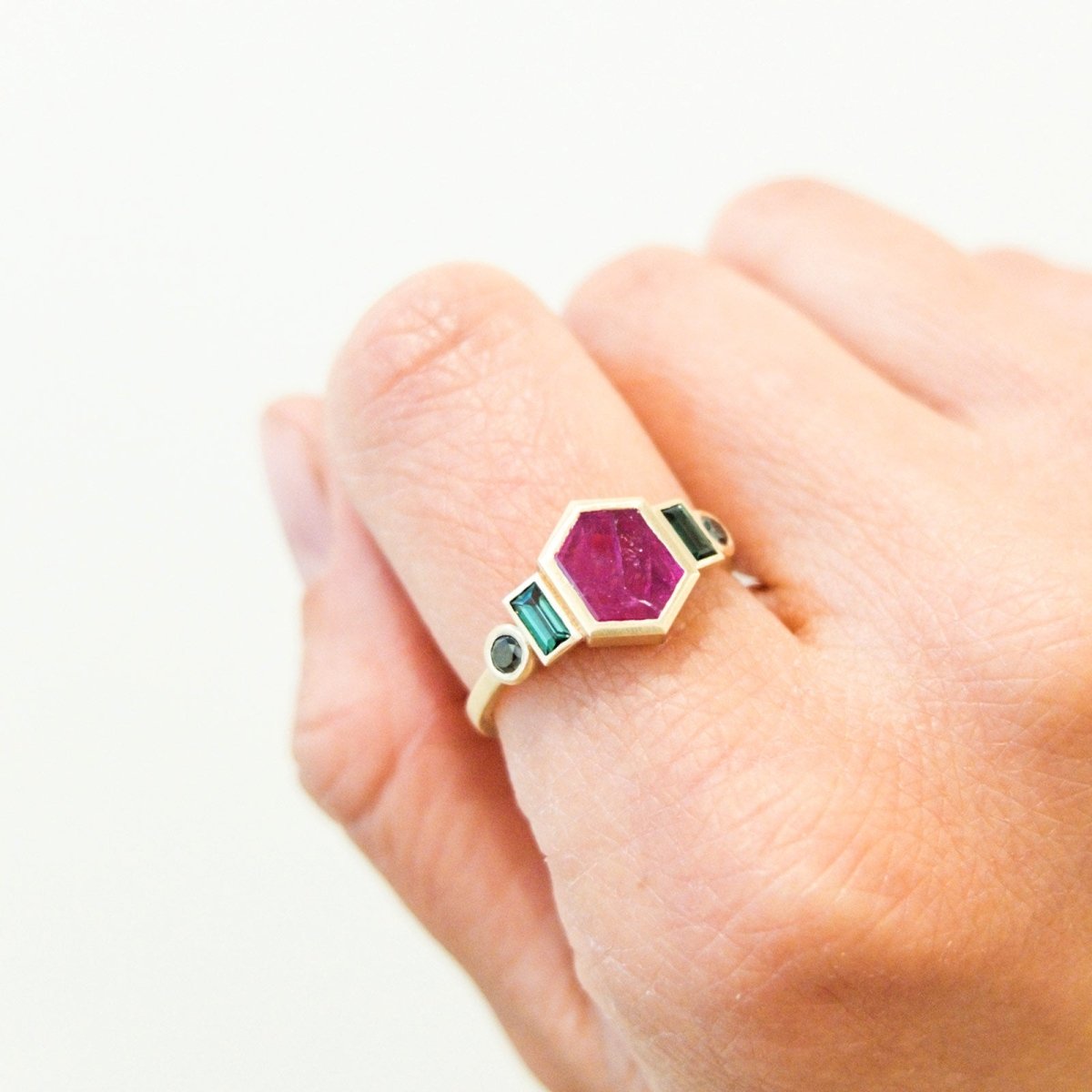 hexagonal 10k gold ruby ring with tourmaline baguettes and black diamond accents