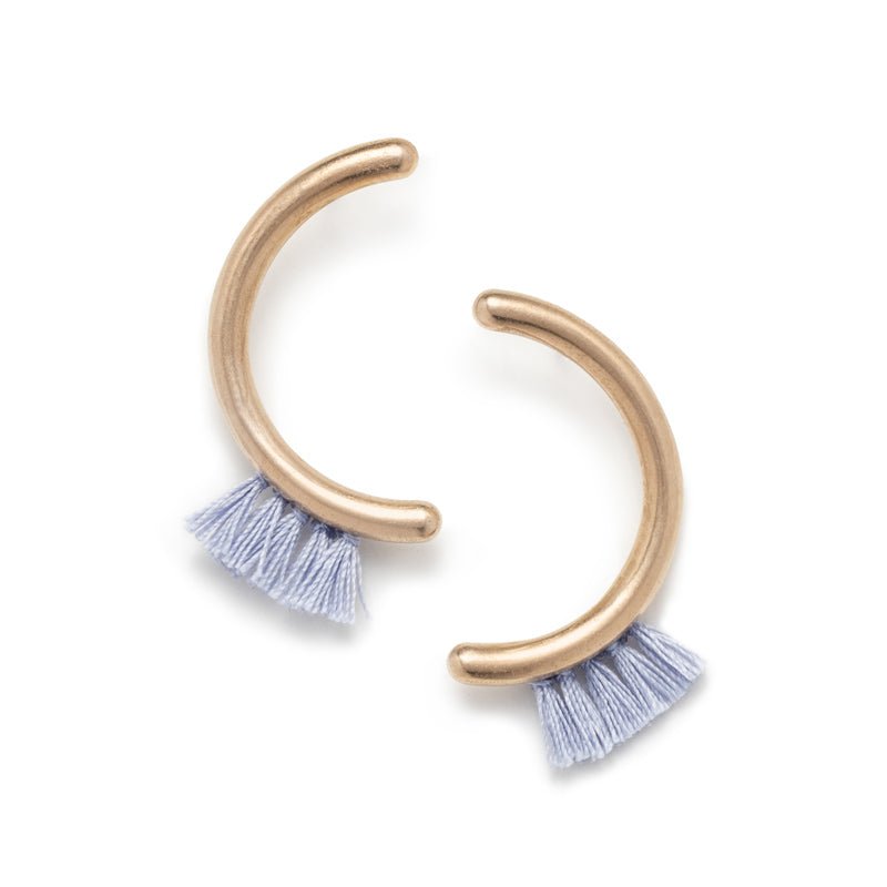 Modern, parentheses-shaped bronze studs with light blue cotton fringe. Hand-crafted in Portland, Oregon.