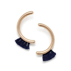 Modern, parentheses-shaped bronze studs with navy cotton fringe. Hand-crafted in Portland, Oregon.