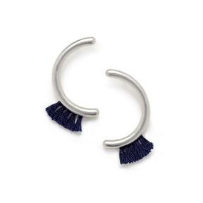 Modern, parentheses-shaped silver studs with navy cotton fringe. Hand-crafted in Portland, Oregon.