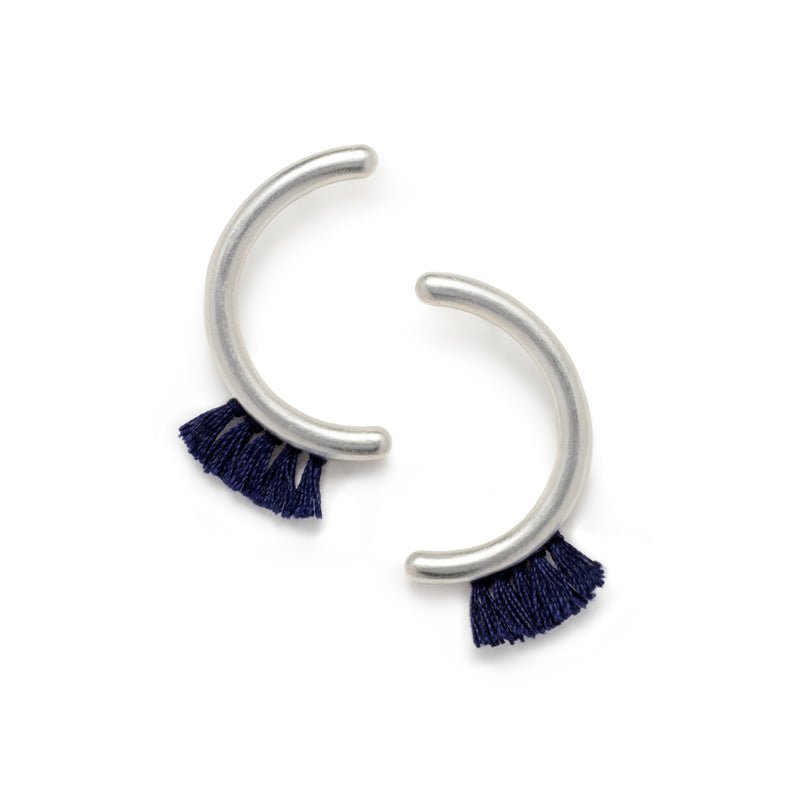 Modern, parentheses-shaped silver studs with navy cotton fringe. Hand-crafted in Portland, Oregon.