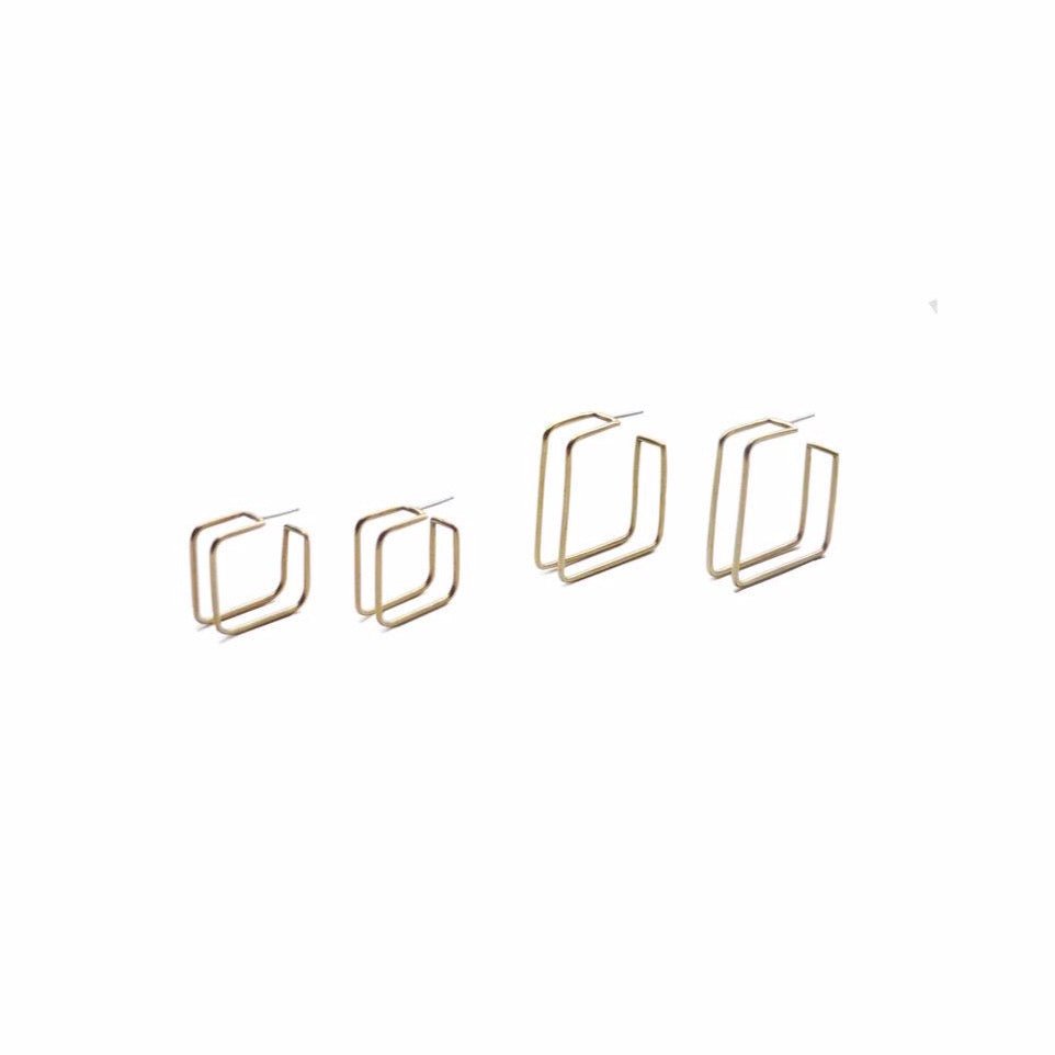 Set of small Square Caged Hoops on Left. Set of large Square Caged Hoops on Right. Made with brass and sterling silver posts. Designed and Handcrafted by Natalie Joy in Portland, Oregon.
