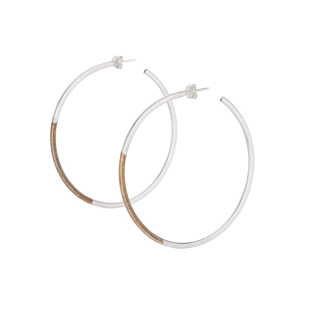 Classic, large, lightweight hoop earrings of mixed brass and sterling silver hand-forged wire, with sterling silver earring posts and sterling silver butterfly backings. Hand-crafted in Portland, Oregon.
