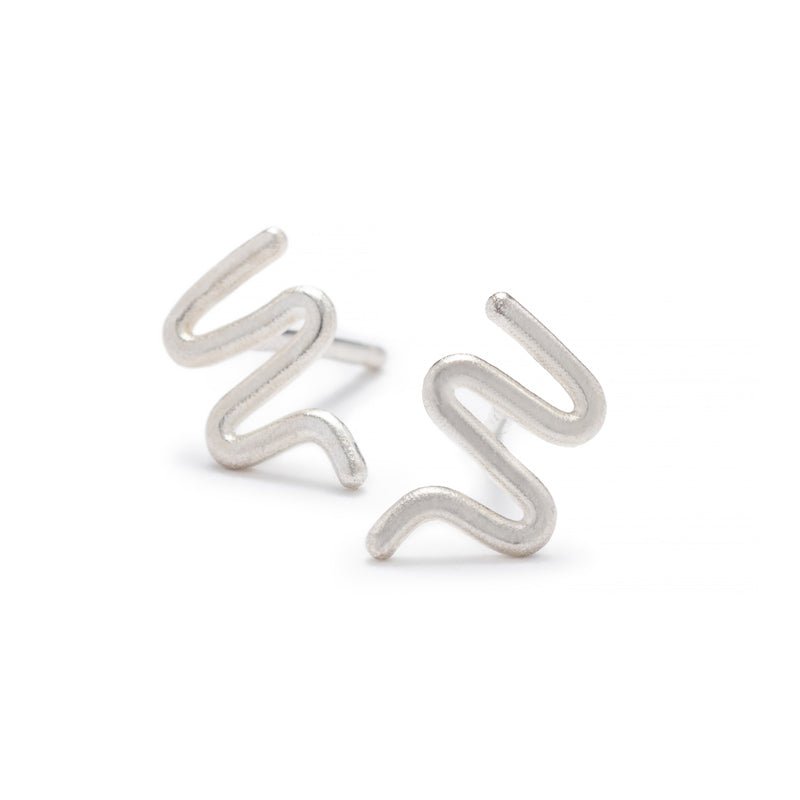 Tiny, silver, snake-inspired studs with sterling silver earring posts. Hand-crafted in Portland, Oregon.